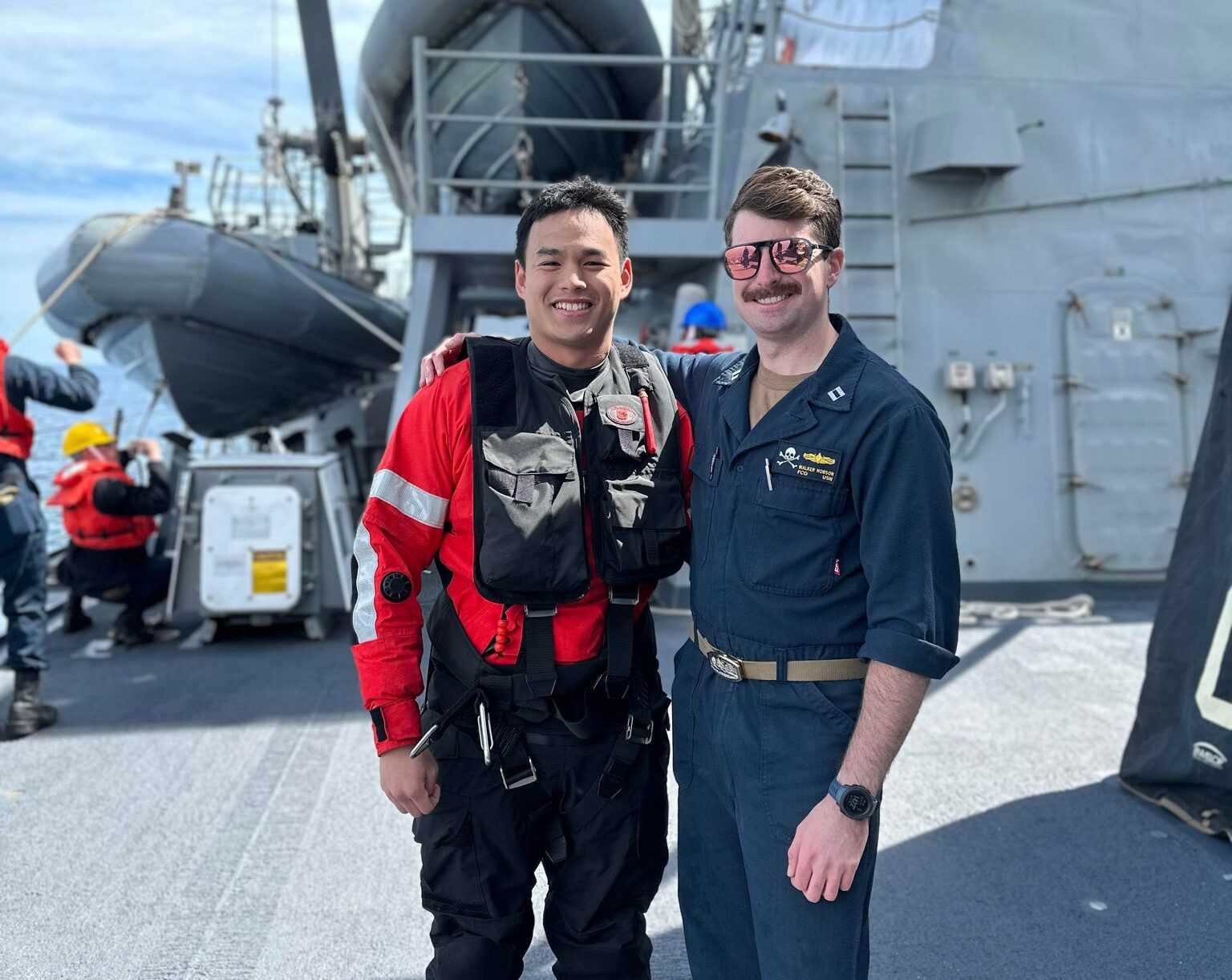Hobson Navy Walker stands with a Search and Rescue Swimmer on the top deck of a US Navy Destroyer.