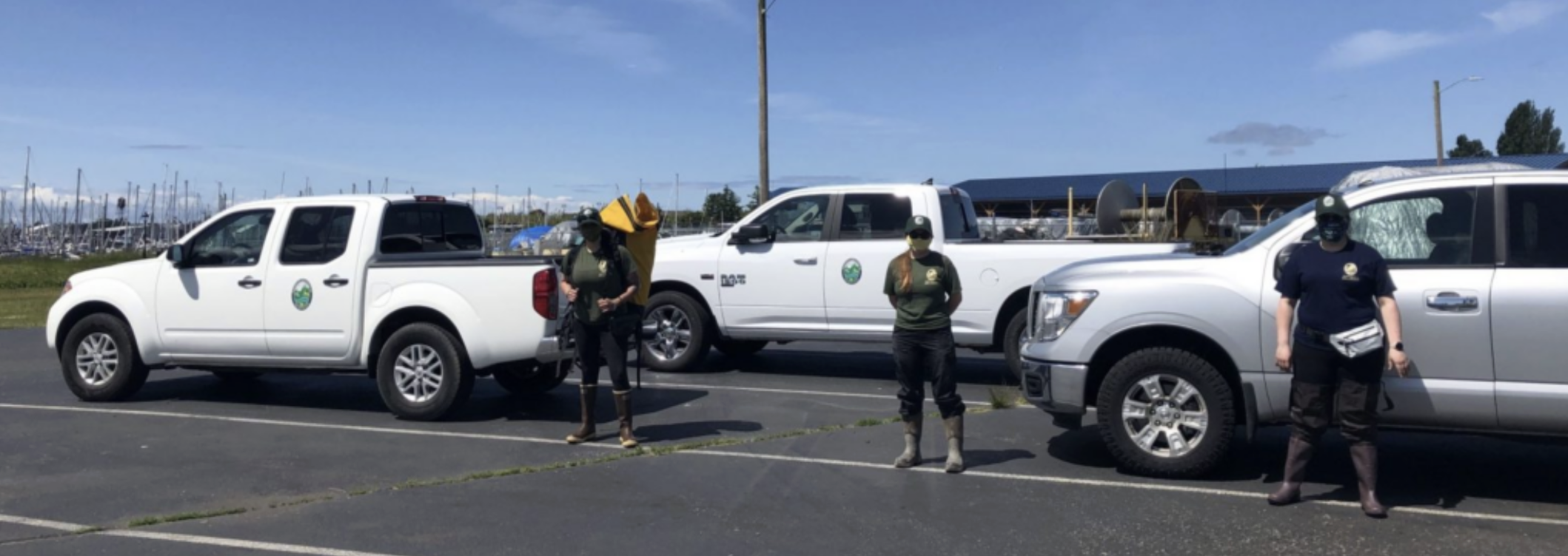 Picture showing three WDFW trucks and three technicians ready to go into the field for the first time.<br />
