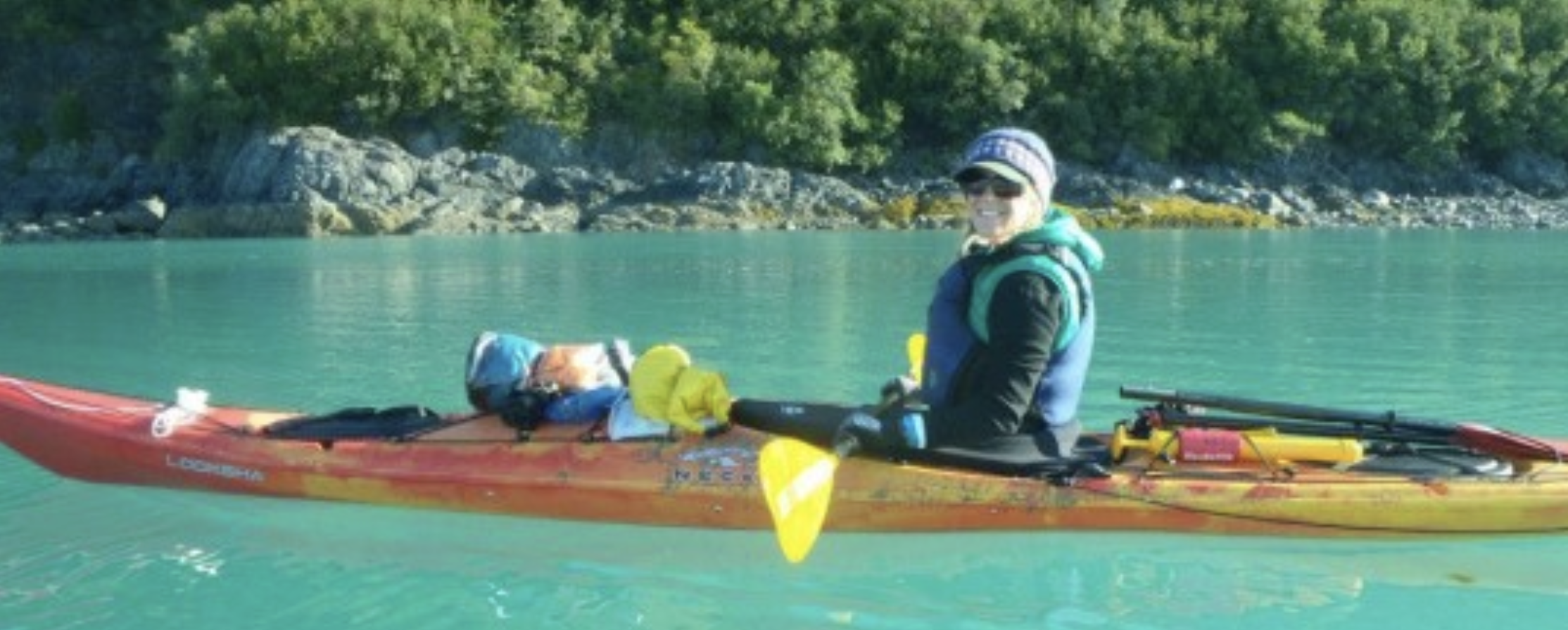 Amy in a kayak on teal waters